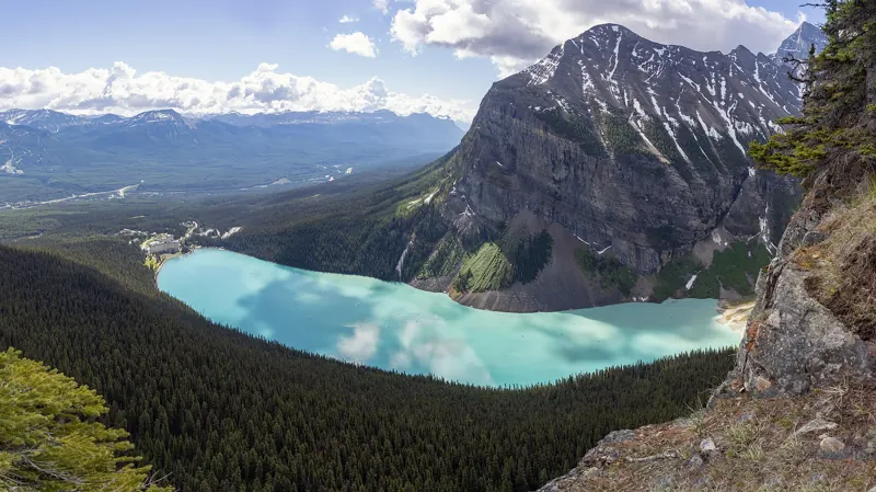 Turquoise Lake Louise seen from a mountain ridge