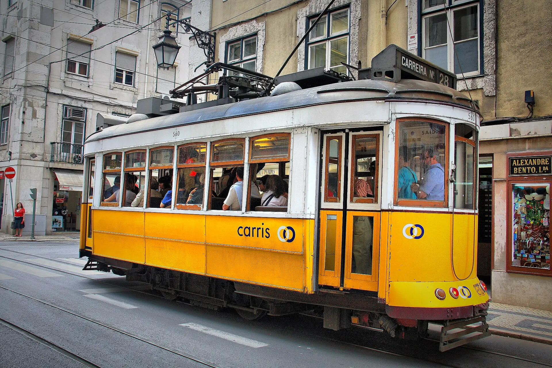 A yellow tram on a Lisbon street
