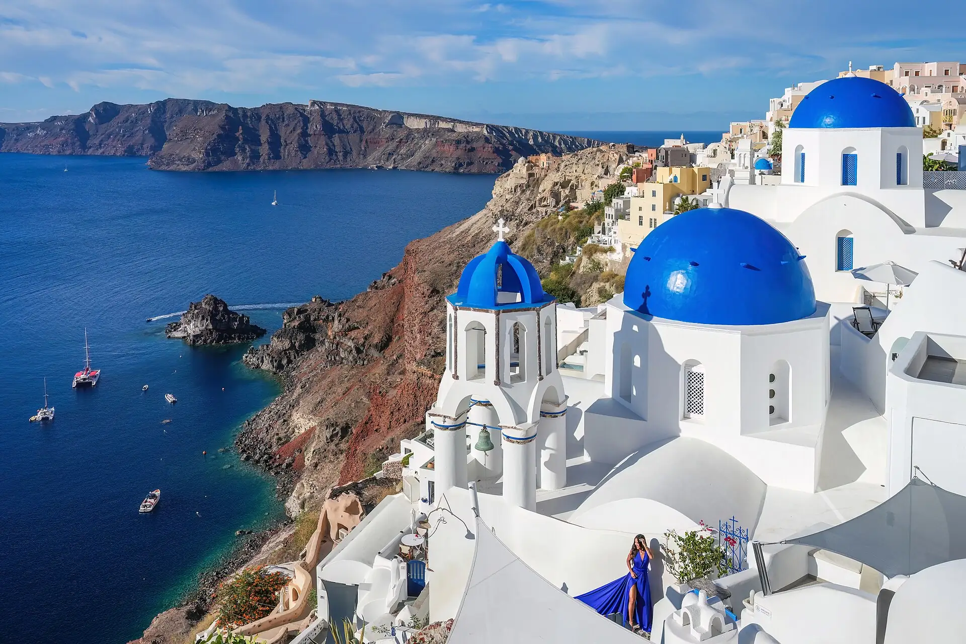 Blue-domed churches and white houses at Oia on Santorini