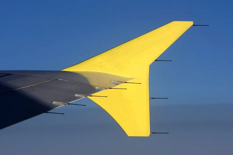 An airplane wing above the clouds