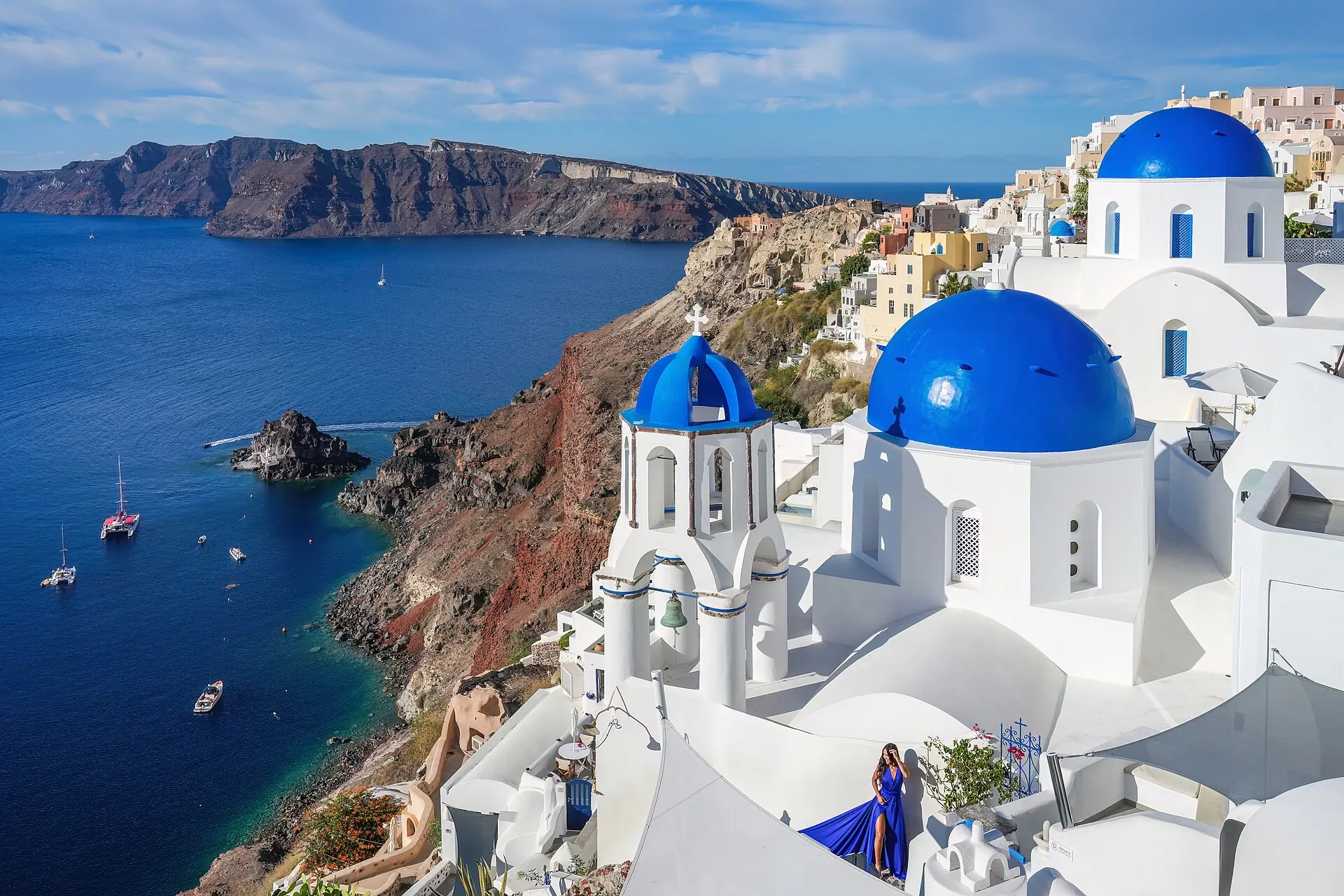White houses and blue-domed churches of Oia, Santorini, above the Aegean