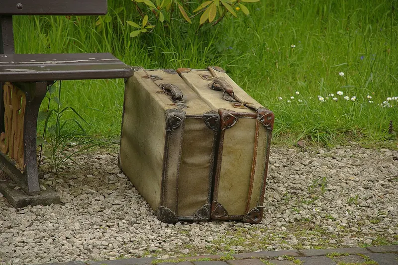 An old suitcase on a bench at a country railway station